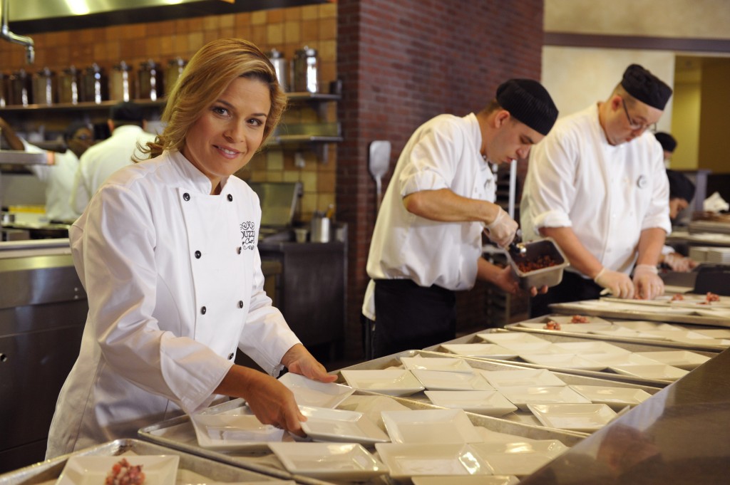 Celebrity chef Cat Cora prepares dishes prior to the grand opening of her first signature restaurant