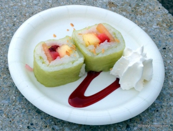 Frushi (Fresh strawberries, pineapple and cantaloupe rolled with coconut rice, atop a raspberry sauce sprinkled with toasted coconut and whipped cream)