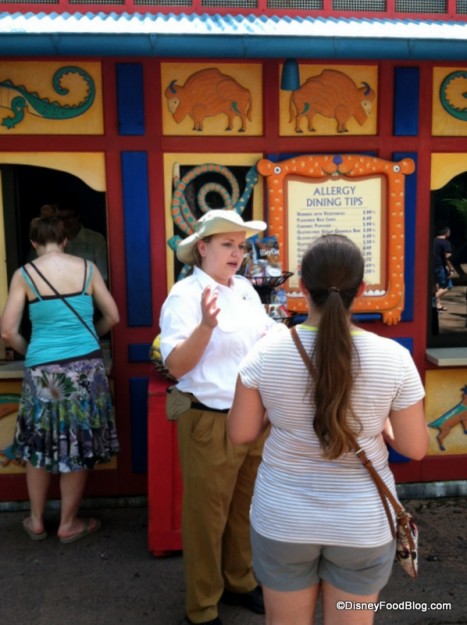 A Cast Member Provides a Guest with Information at the Gardens Kiosk in Disney's Animal Kingdom