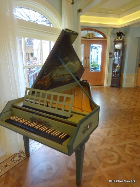 Lillian Disney's harpsichord a top the beautiful inlaid wood floors.