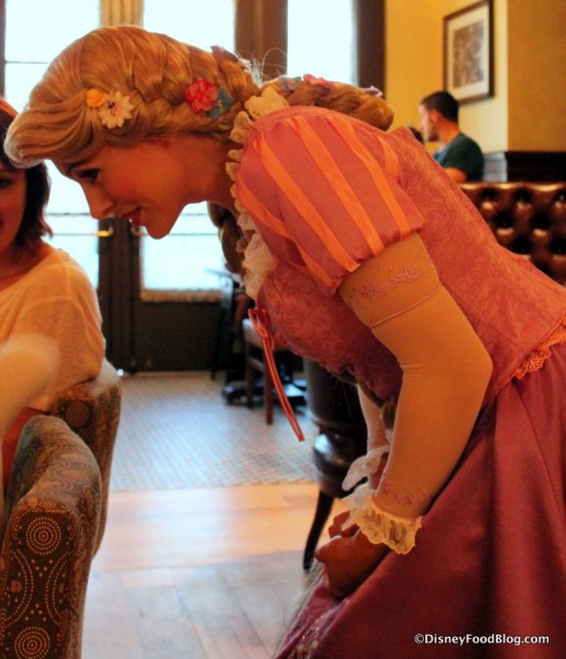 Rapunzel speaking to a young guest