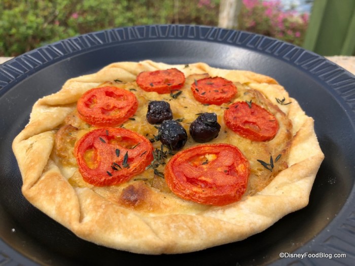 2018-Epcot-Flower-and-Garden-Festival-Fleur-de-Lys-Provencal-Tomato-Tart-with-Saut%C3%A9ed-Onions-Fresh-Thyme-and-Rosemary-on-a-Flaky-Pastry-Crust-700x525.jpg