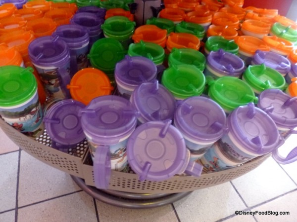 Green, purple, and orange mugs