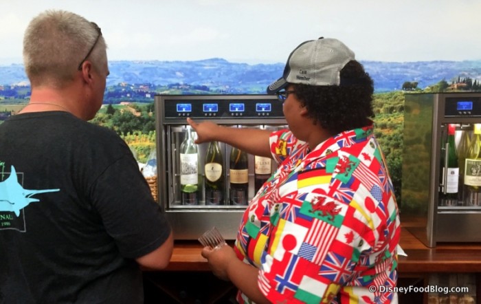 Cast Member Assisting a Guest with the Wine Tasting Machines