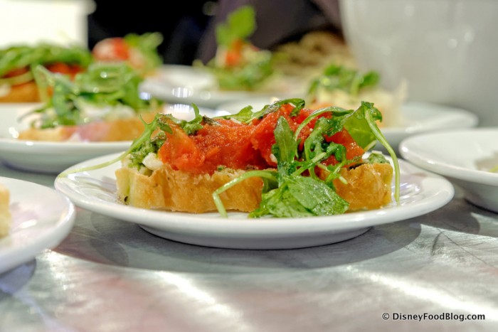 Bruschetta topped with Roasted Tomatoes, Pesto, Herbed Ricotta and Arugula