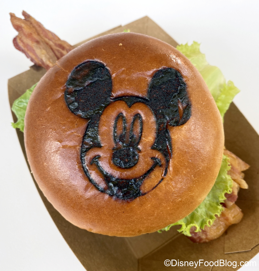 Review We Re Trying The Mickey Monster Mash Burger Topped With Sriracha In Disney World The Disney Food Blog