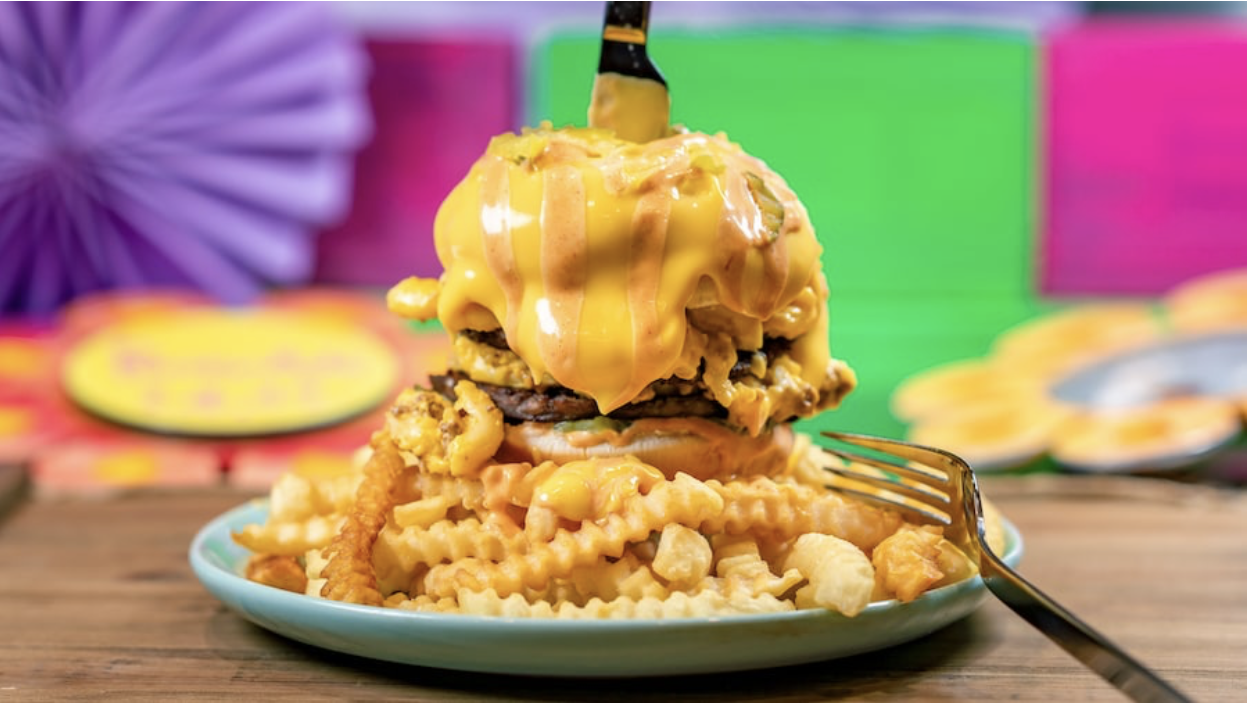 Cheeseburger Mac Burger, which comes with double burger patties topped with cheeseburger mac, burger sauce, pickles, and cheese sauce served with crinkle-cut fries. 