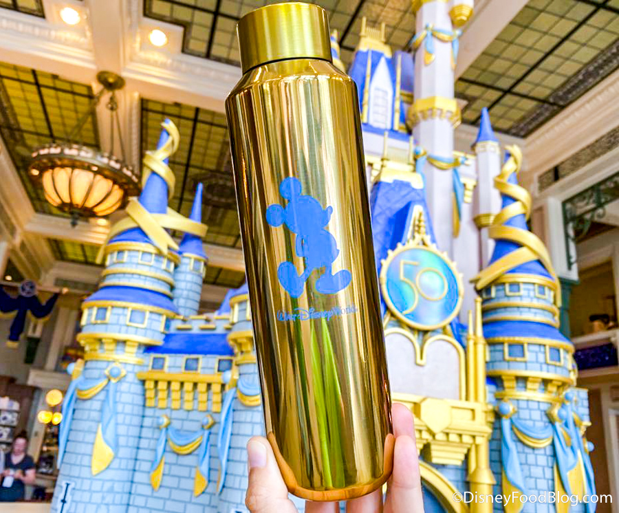 https://www.disneyfoodblog.com/wp-content/uploads/2022/06/Starbucks-Water-Bottle-Gold-50th-Anniversary-Magic-Kingdom-Disney-World-4.jpg