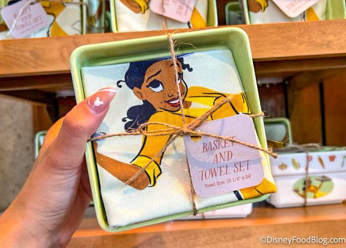 https://www.disneyfoodblog.com/wp-content/uploads/2022/07/2022-wdw-epcot-food-and-wine-festival-port-of-entry-merchandise-princess-tiana-basket-and-towel-set-700x501.jpg